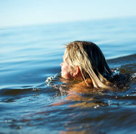 Girl swimming in the waterの写真素材