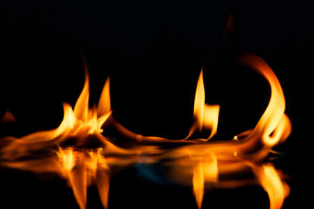 Beautiful stylish fire flames reflected in waterの写真素材