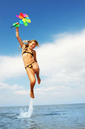 Happy little girl jumpingの写真素材