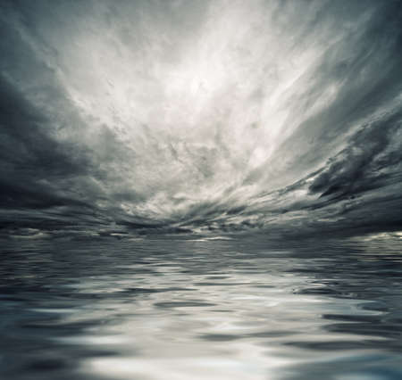 Dramatic sky reflected in sea waterの写真素材