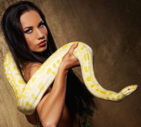 Attractive brunette woman with pythonの写真素材