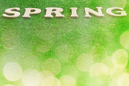 The word spring written on green backgroundの写真素材