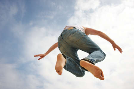Man jumping against blue sky