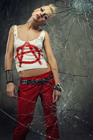 Punk girl behind broken glassの写真素材