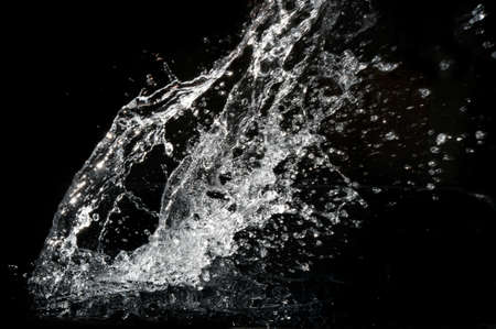 Stylish water splash. Isolated on black backgroundの写真素材