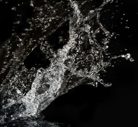 Stylish water splash. Isolated on black backgroundの写真素材