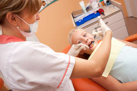 Teenage girl at a dentist.の写真素材