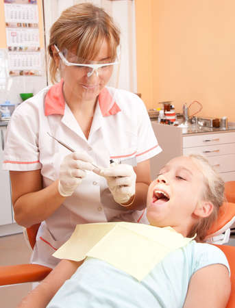 Teenage girl at a dentist.の写真素材
