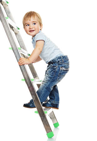 Cute little boy climbing on a ladder.の写真素材