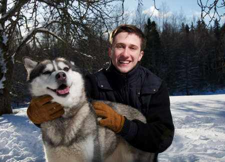 Happy man with a dogの写真素材