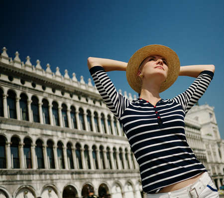 Beautiful woman in hat against Dodge's Palaceの写真素材