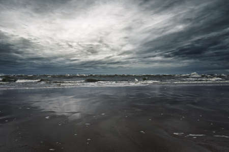 Stormy sky over sandy shoreの写真素材