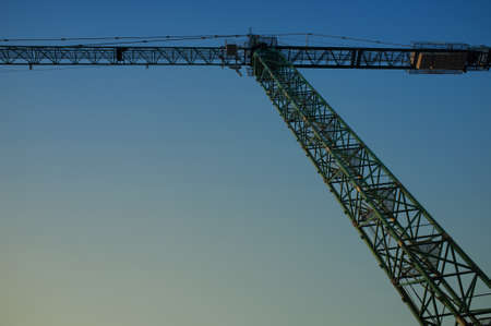 Hoisting crane against evening skyの写真素材