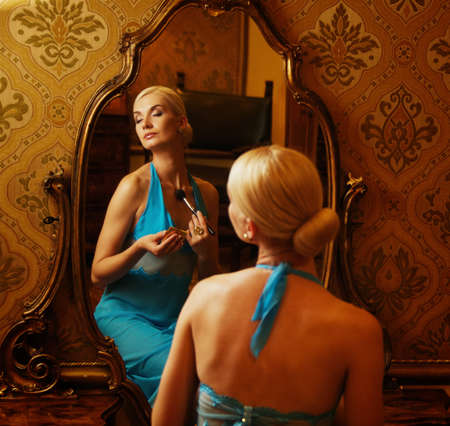 Woman in blue dress reflected in mirrorの写真素材