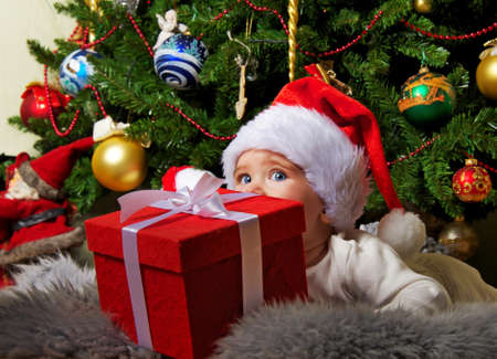 Santa baby playing with gift box