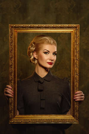 Retro woman with picture frame.の写真素材