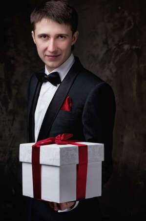 Young man with a gift box.の写真素材