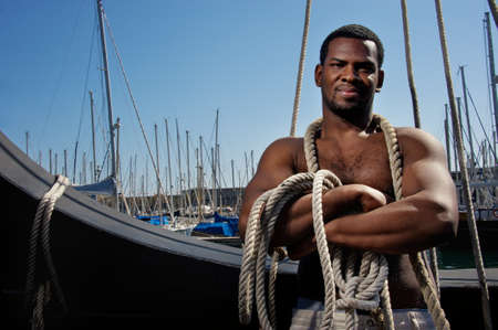 Handsome afro-american sailor against boats の写真素材