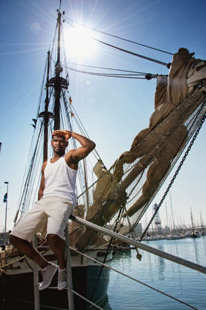 Handsome afro-american man against boat in port の写真素材