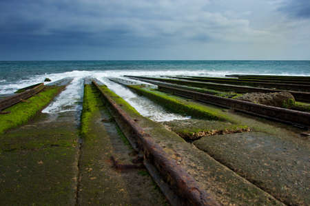 Old rails for descending boat into water.の写真素材