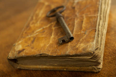 Old metal key on vintage book.の写真素材