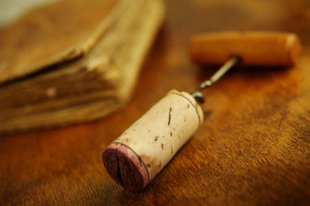 Corkscrew near a vintage book.