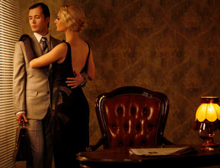 Couple in retro interior near a window.の写真素材