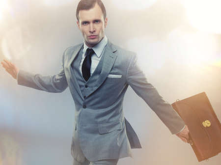 Businessman with a briefcase on abstract backgroundの写真素材