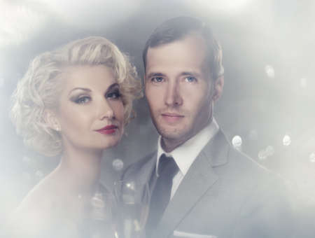 Retro couple with glasses of champagne portrait