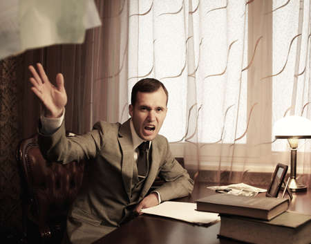 Angry businessman throwing a documents