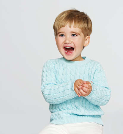 Happy baby boy in blue pulloverの写真素材