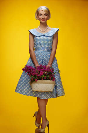 Lovely woman in a blue dress with a flowers