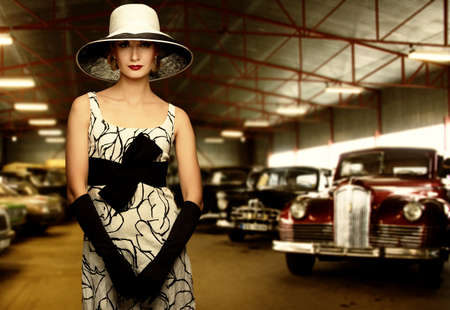 Woman in hat in retro garageの写真素材
