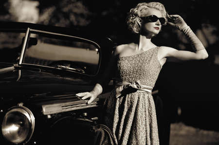 Woman near a retro car outdoorsの写真素材
