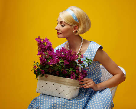 Lovely woman in a blue dress with a flowersの写真素材