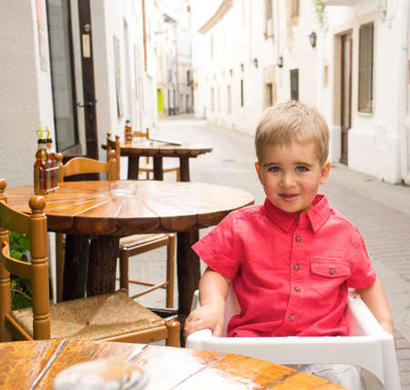 Little boy in steet cafeの写真素材