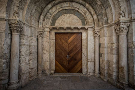 Wooden door in ancient archwayの写真素材
