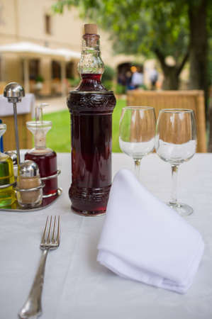 Table setting with bottle of wine in restaurantの写真素材