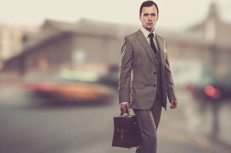 Man in classic grey suit with briefcase  outdoorsの写真素材