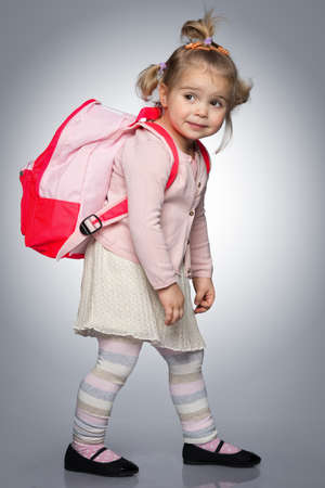 Funny little girl with backpack の写真素材