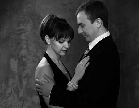 Monochrome picture of young man and woman in elegant evening dressの写真素材