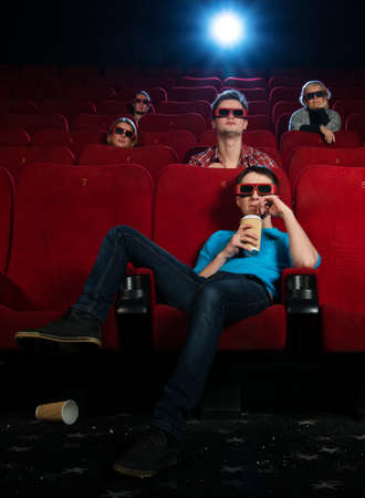 People in 3D glasses watching movie in cinemaの写真素材