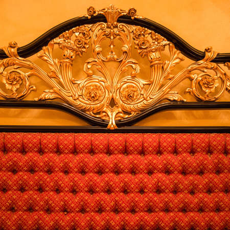 Back of expensive sofa with golden ornamentの写真素材