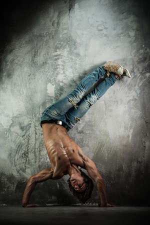 Young b-boy man with torso doing brake dancing movements 