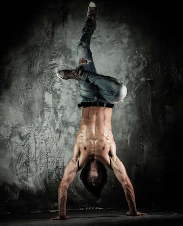 Young b-boy man with torso doing brake dancing movements の写真素材