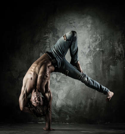 Young b-boy man with torso doing brake dancing movements 