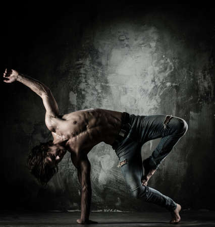 Young b-boy man with torso doing brake dancing movements 