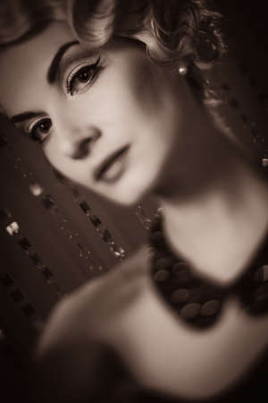 Toned picture of elegant blond retro woman with beautiful hairdo