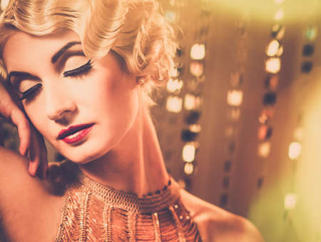 Elegant blond retro woman  in golden dress with beautiful hairdo and red lipstick