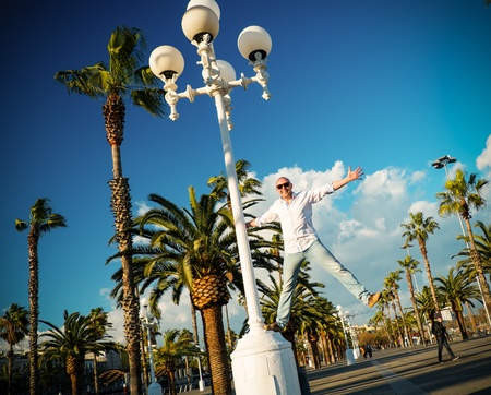 Happy middle-aged man in white shirt outdoorsの写真素材
